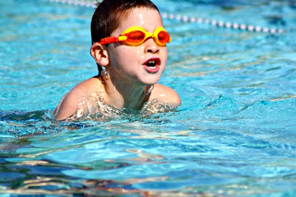 Boy Swimming Safely in Pool